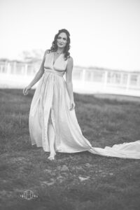 Black and white photo of women walking with long dress