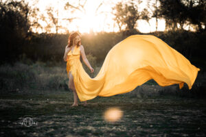 Light reflection from sunset with model in yellow dress