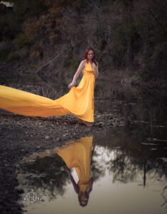 Women looking at reflection with long yellow dress