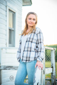 Girl posing on porch for senior photos