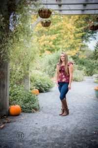 Girl posing in a garden for her senior photos