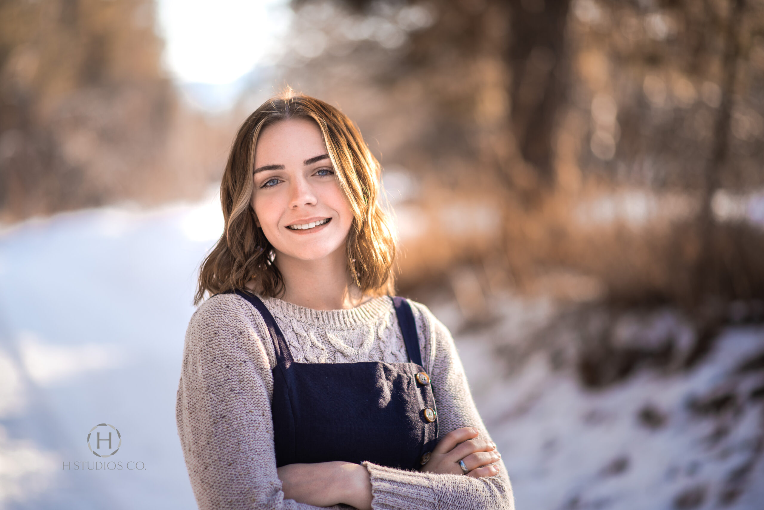 Senior class girl standing in a snowy road way for photos